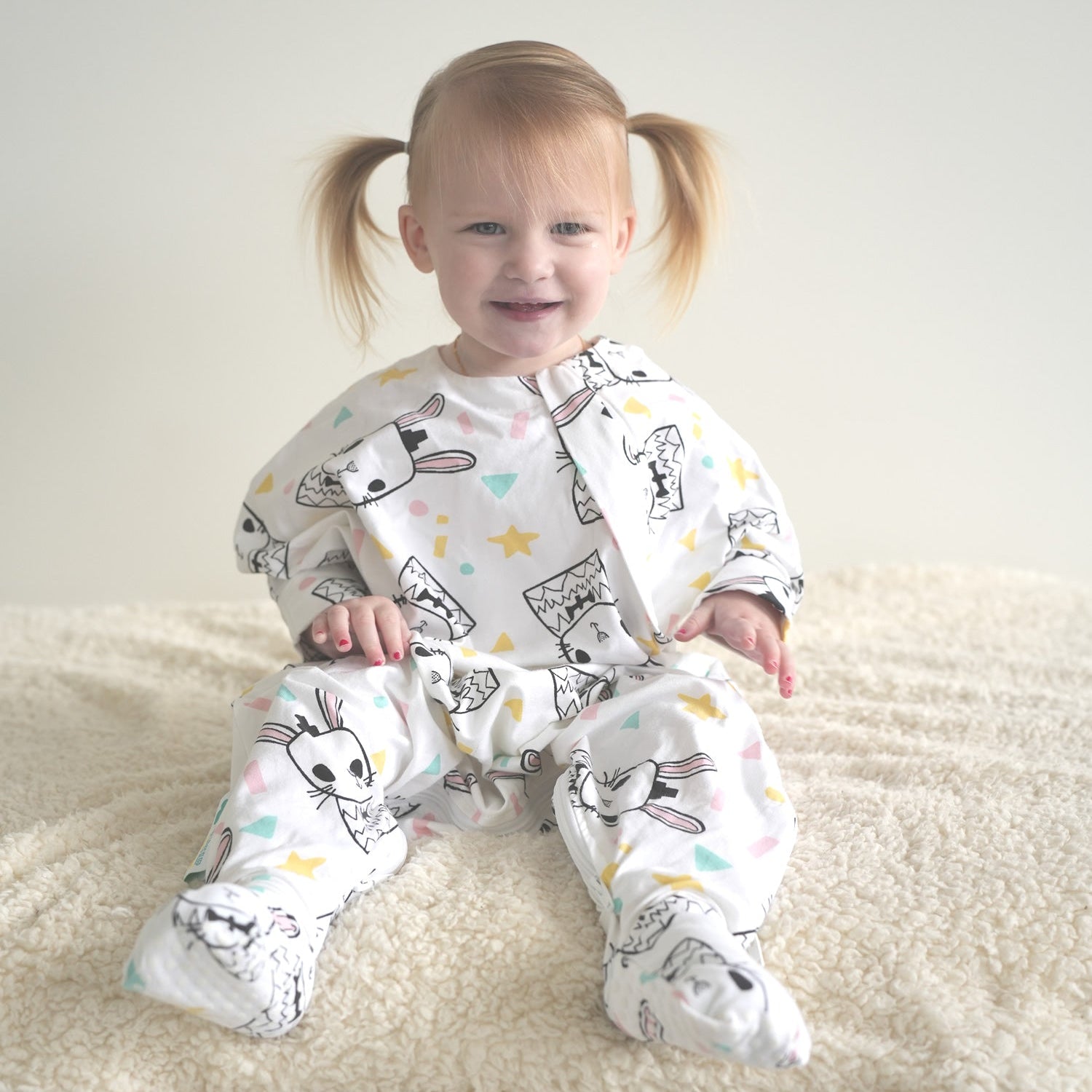 Toddler wearing a cute rabbit patterned sleep onesie