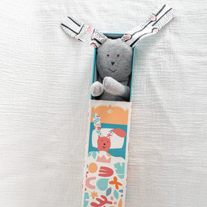 soft grey bunny toy with doll bed