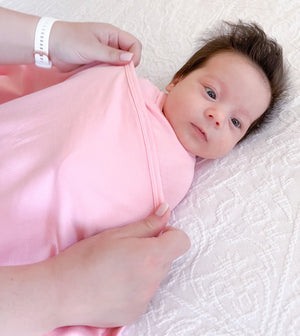 Koala Hugs newborn swaddle wrap gently cocoons baby's arms to help calm the startle reflex.