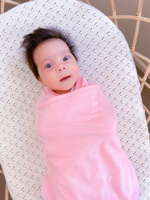 Koala Hugs newborn swaddle wrap gently cocoons baby's arms to help calm the startle reflex.