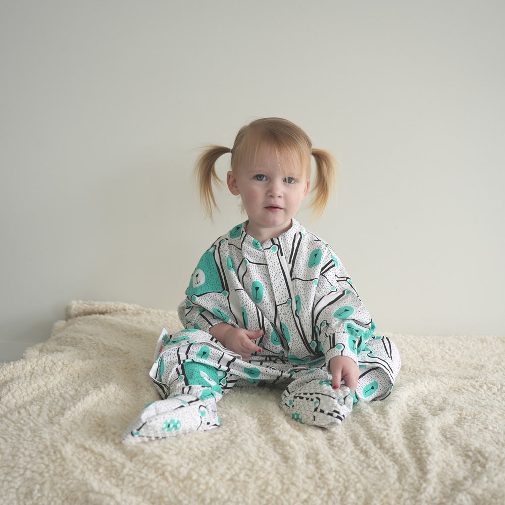 Toddler sleep onesie made of soft organic cotton with anti slip dots on feet covers