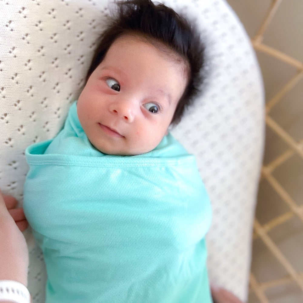 Koala Hugs newborn swaddle wrap gently cocoons baby's arms to help calm the startle reflex.