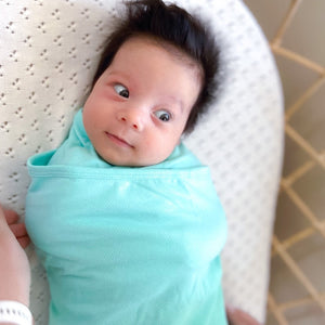 Koala Hugs newborn swaddle wrap gently cocoons baby's arms to help calm the startle reflex.